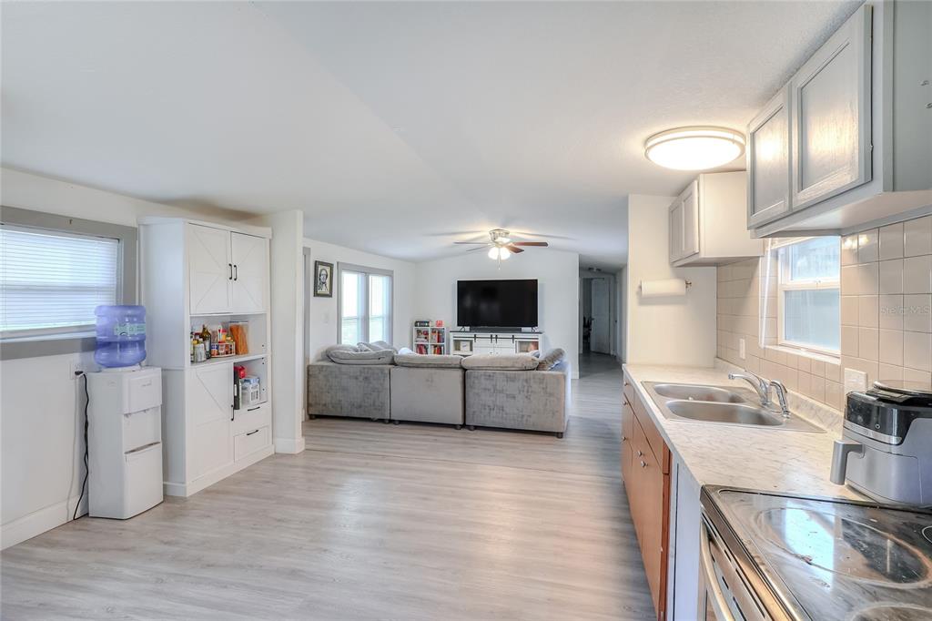 12552 Farmettes Road Lakeland, FL 33809 - Photo 5 of 43 a living room with furniture and a wooden floor