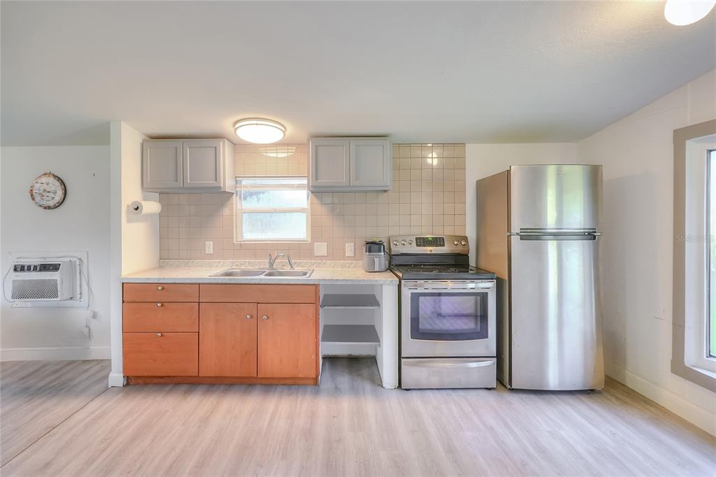 12552 Farmettes Road Lakeland, FL 33809 - Photo 7 of 43 a kitchen with stainless steel appliances granite countertop a stove a sink and a refrigerator