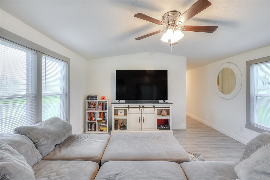 12552 Farmettes Road Lakeland, FL 33809 - Photo 8 of 43 a living room with furniture and a flat screen tv