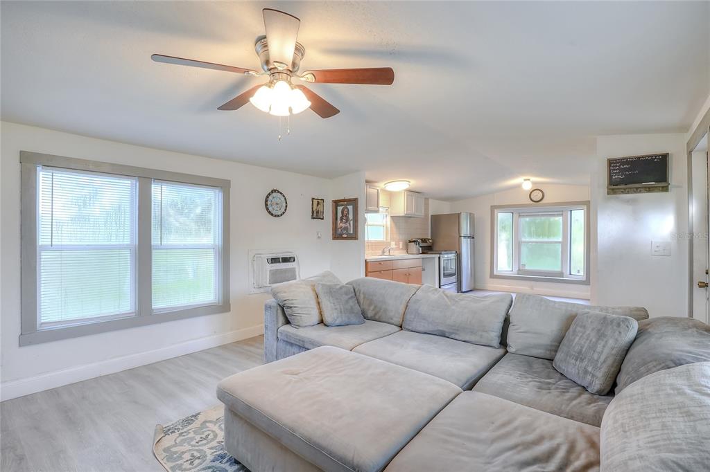 12552 Farmettes Road Lakeland, FL 33809 - Photo 9 of 43 a living room with furniture and a large window