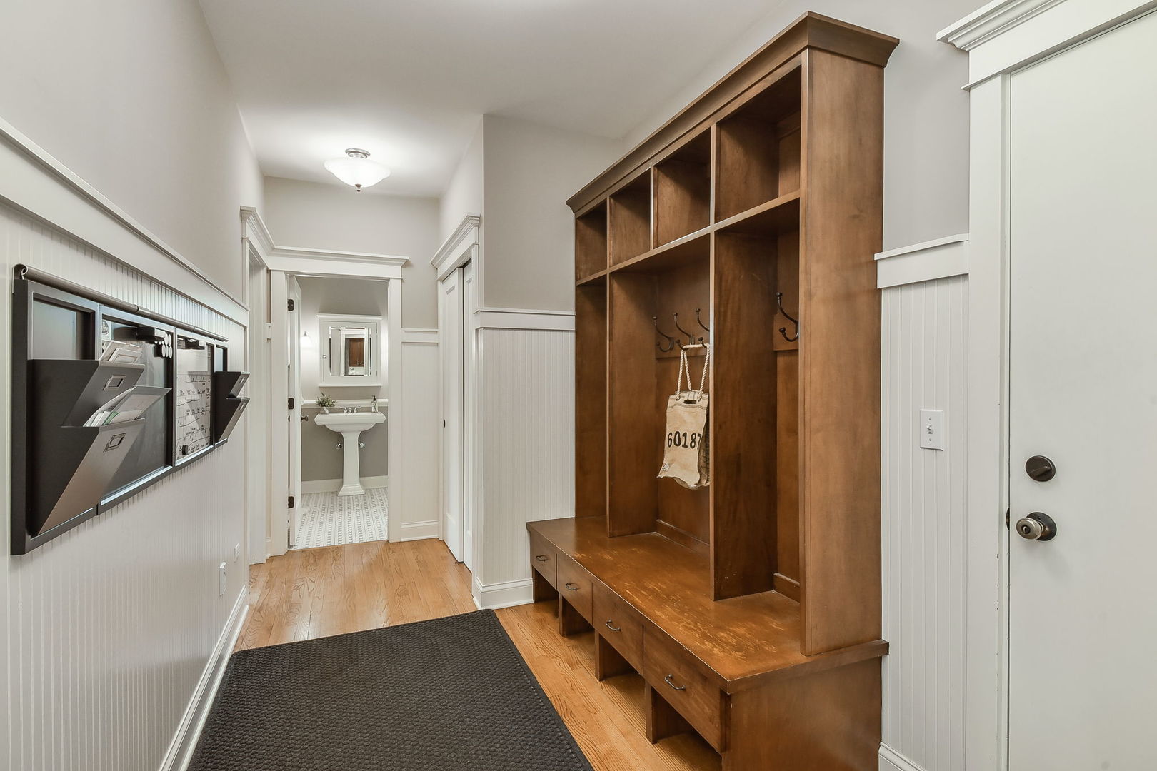 427 Ranch Road Wheaton, IL 60187 - Photo 14 of 38 a hallway with white cabinets and wooden floor