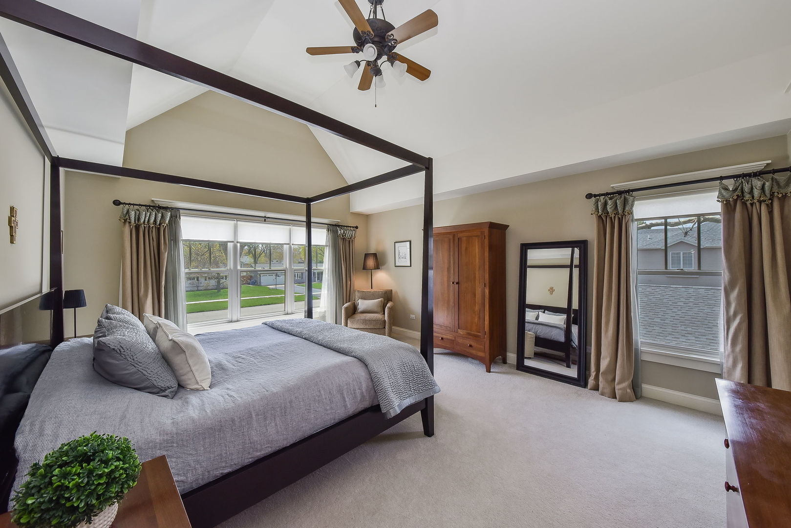 427 Ranch Road Wheaton, IL 60187 - Photo 17 of 38 a large bedroom with a bed and a chandelier