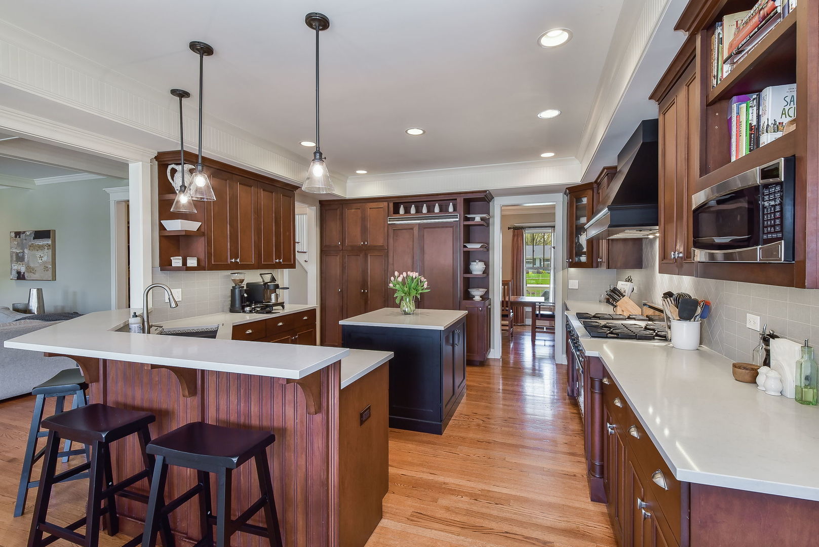 427 Ranch Road Wheaton, IL 60187 - Photo 5 of 38 a kitchen with stainless steel appliances granite countertop a stove top oven a sink dishwasher a dining table and chairs with wooden floor