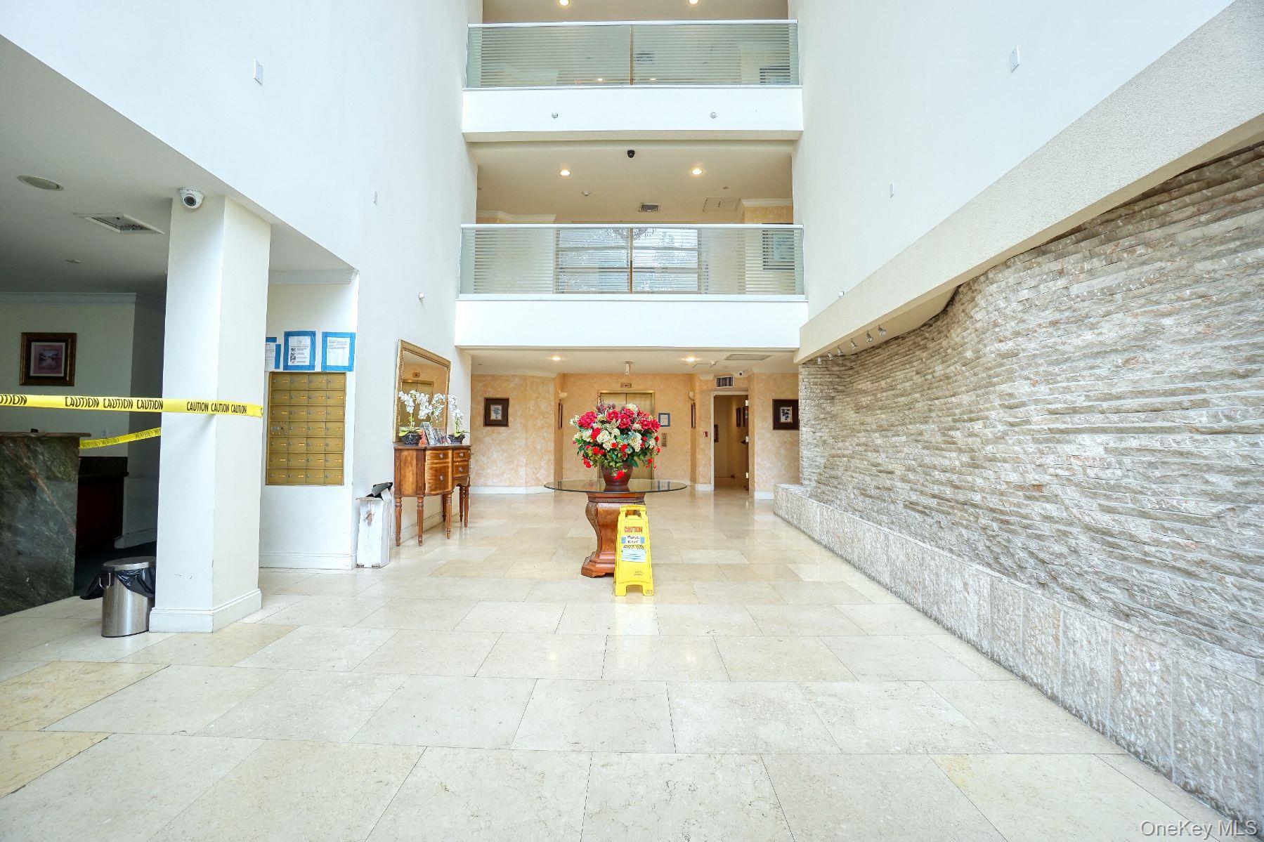 171 Great Neck Road, Unit 3B Great Neck, NY 11021 - Photo 11 of 15 Building lobby with a high ceiling