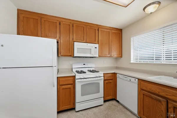 a kitchen with a refrigerator a stove a sink and a refrigerator