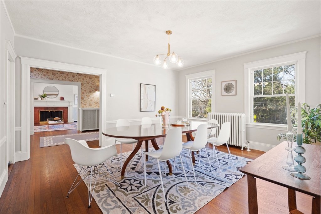 1066 Walnut Street Newton, MA 02461 - Photo 11 of 37 a living room with furniture a wooden floor and a large window
