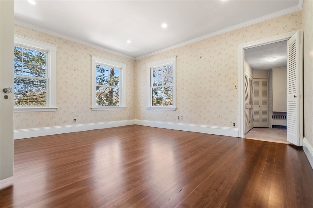 1066 Walnut Street Newton, MA 02461 - Photo 19 of 37 an empty room with wooden floor and windows