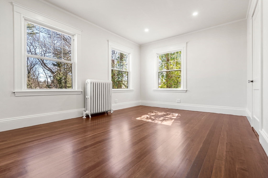1066 Walnut Street Newton, MA 02461 - Photo 20 of 37 a view of an empty room with wooden floor and a window