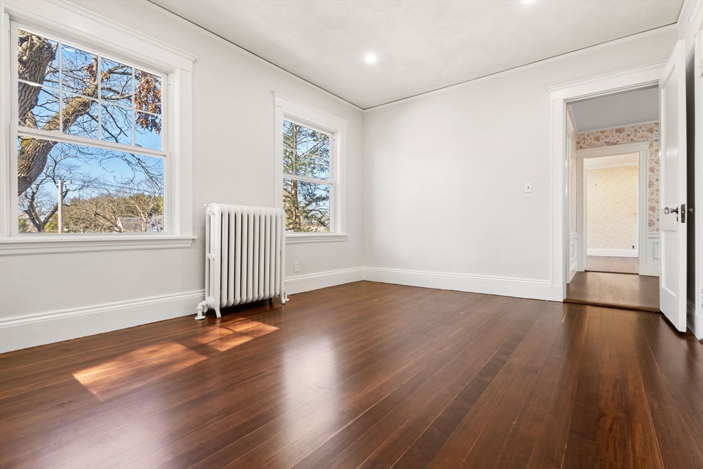 1066 Walnut Street Newton, MA 02461 - Photo 21 of 37 a view of empty room with wooden floor and fan