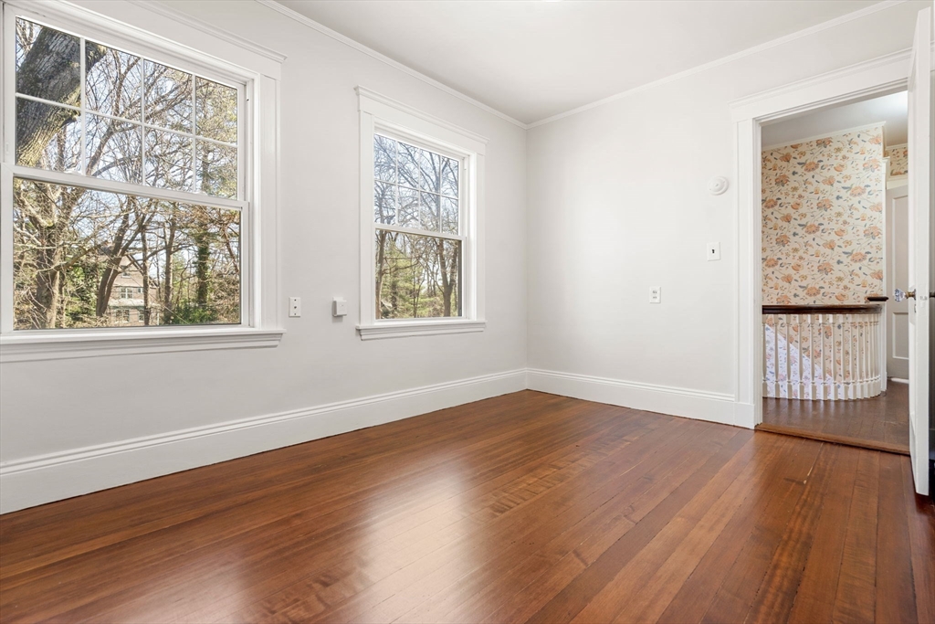 1066 Walnut Street Newton, MA 02461 - Photo 22 of 37 a view of an empty room with wooden floor and a window