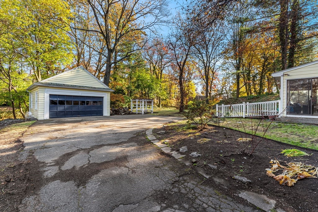 1066 Walnut Street Newton, MA 02461 - Photo 35 of 37 a front view of a house with a yard and garage