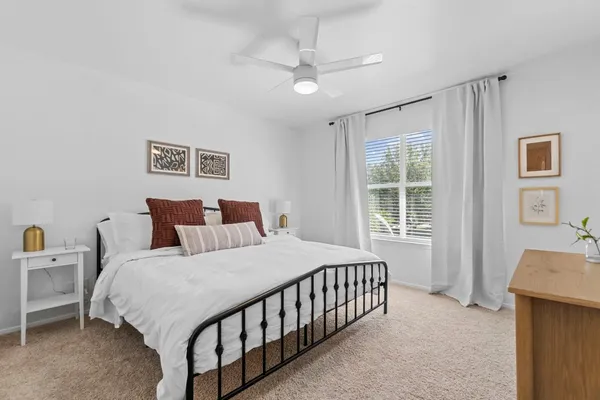 a bedroom with a large bed and a chandelier