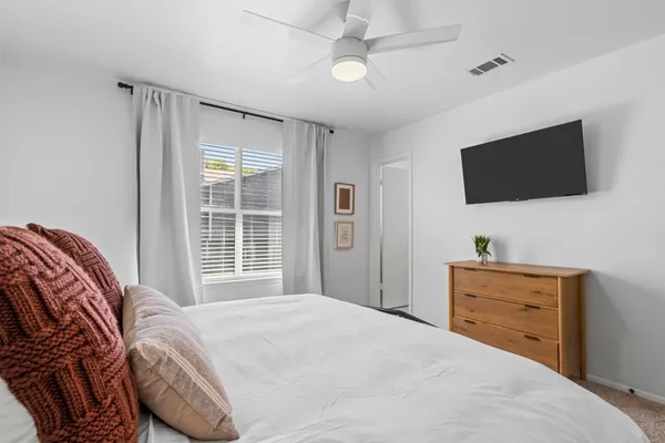 a bedroom with a bed and a flat screen tv