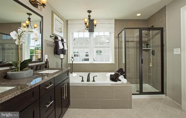 7682 Elmcrest Road Hanover, MD 21076 - Photo 11 of 21 a large spacious bathroom with a granite countertop tub sink a mirror and shower