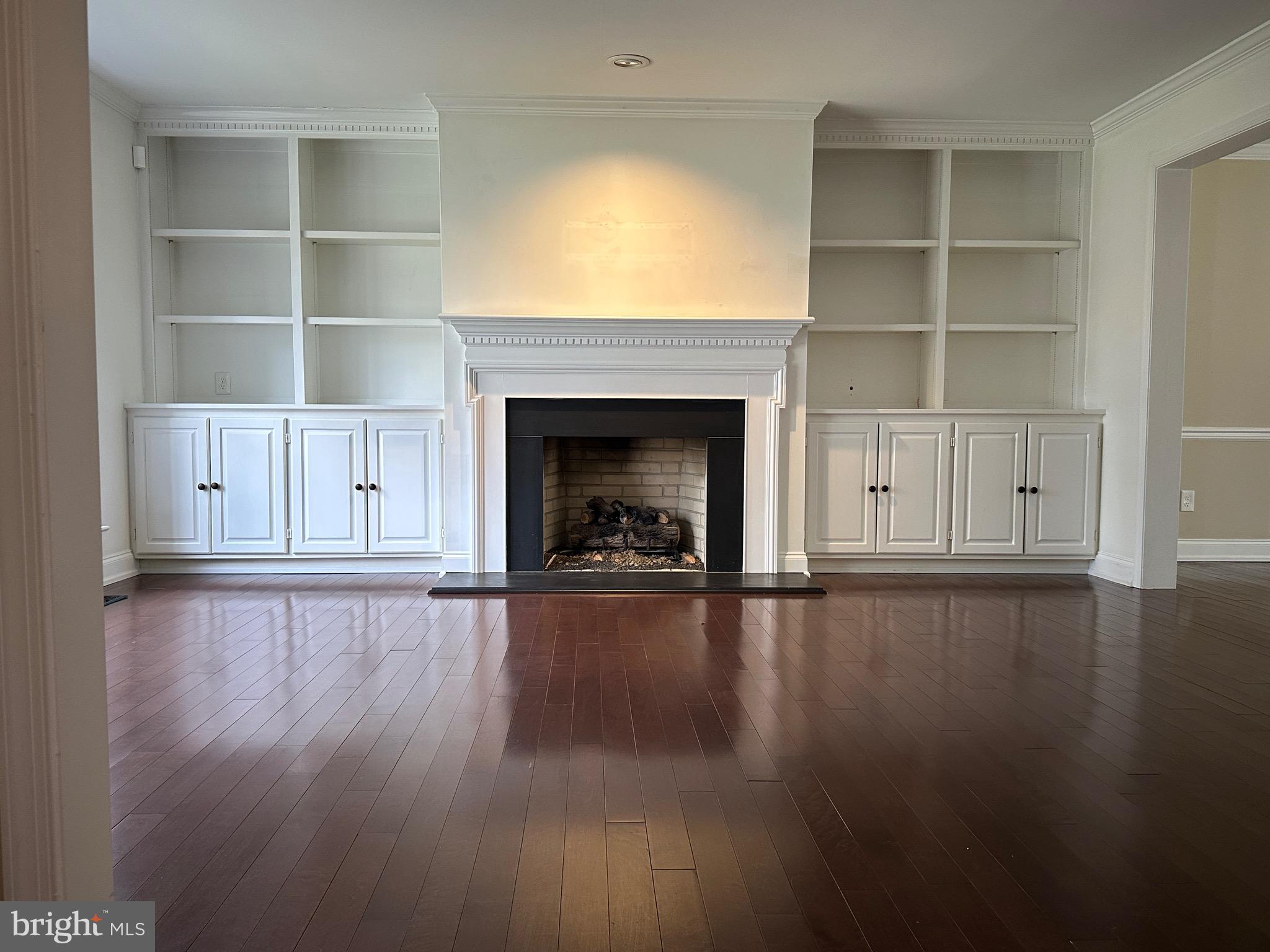 418 Waynesbrooke Road Berwyn, PA 19312 - Photo 4 of 30 a view of empty room with wooden floor and fireplace