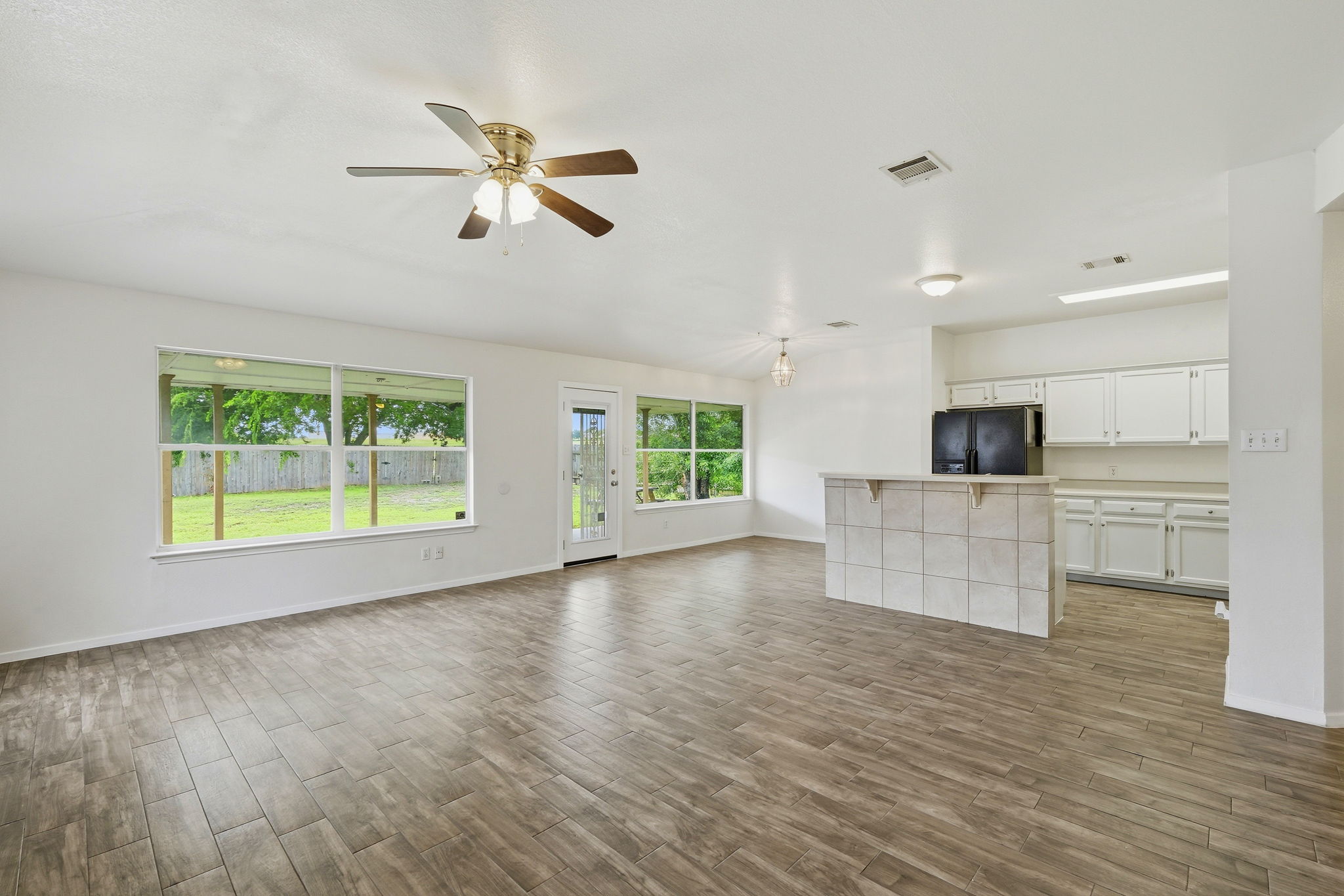 1005 Rolling Ridge Drive Round Rock, TX 78665 - Photo 3 of 18 An inviting open-concept living space features durable wood-look tile flooring and abundant natural light.