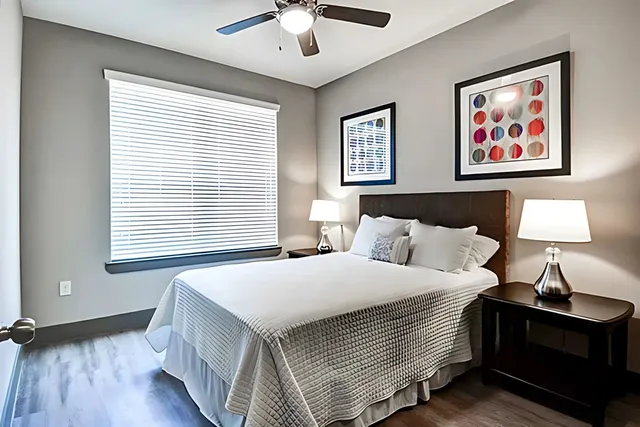 a bedroom with bed and a window