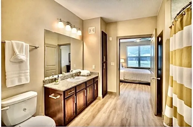 a bathroom with a toilet a sink and a mirror