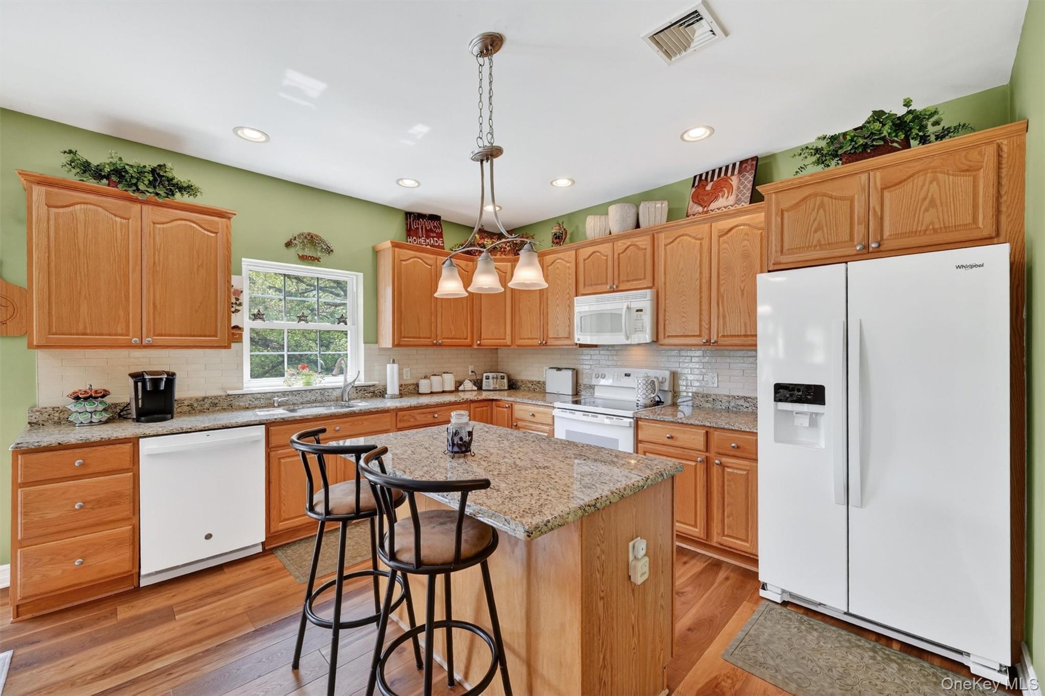 19 Pirog Road Pine Bush, NY 12566 - Photo 8 of 50 a kitchen with stainless steel appliances granite countertop a refrigerator a sink dishwasher a stove and white countertops with wooden floor
