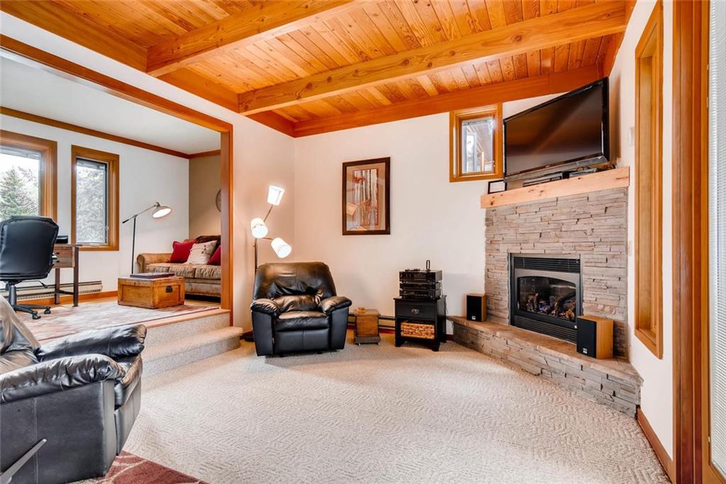 650 Tennis Club Road, Unit 1340 Keystone, CO 80435 - Photo 2 of 25 a living room with furniture a fireplace and a flat screen tv