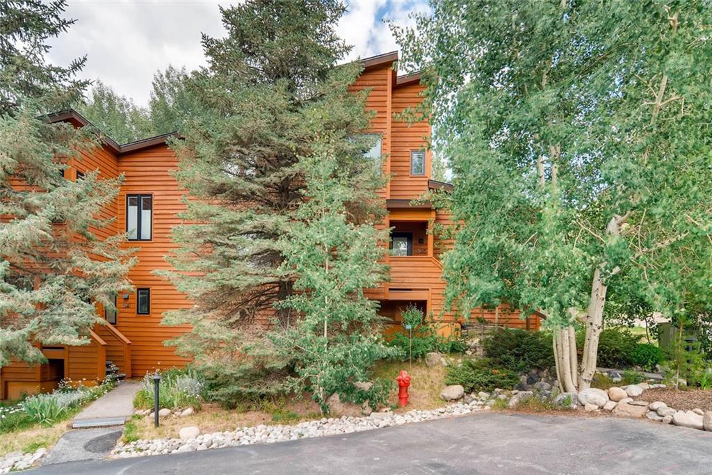 650 Tennis Club Road, Unit 1340 Keystone, CO 80435 - Photo 18 of 25 a yellow building with trees in front of it