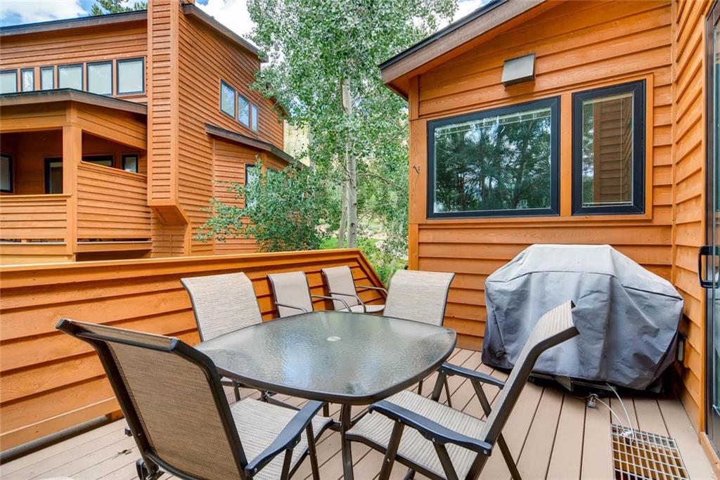 650 Tennis Club Road, Unit 1340 Keystone, CO 80435 - Photo 22 of 25 a backyard of a house with barbeque oven table and chairs