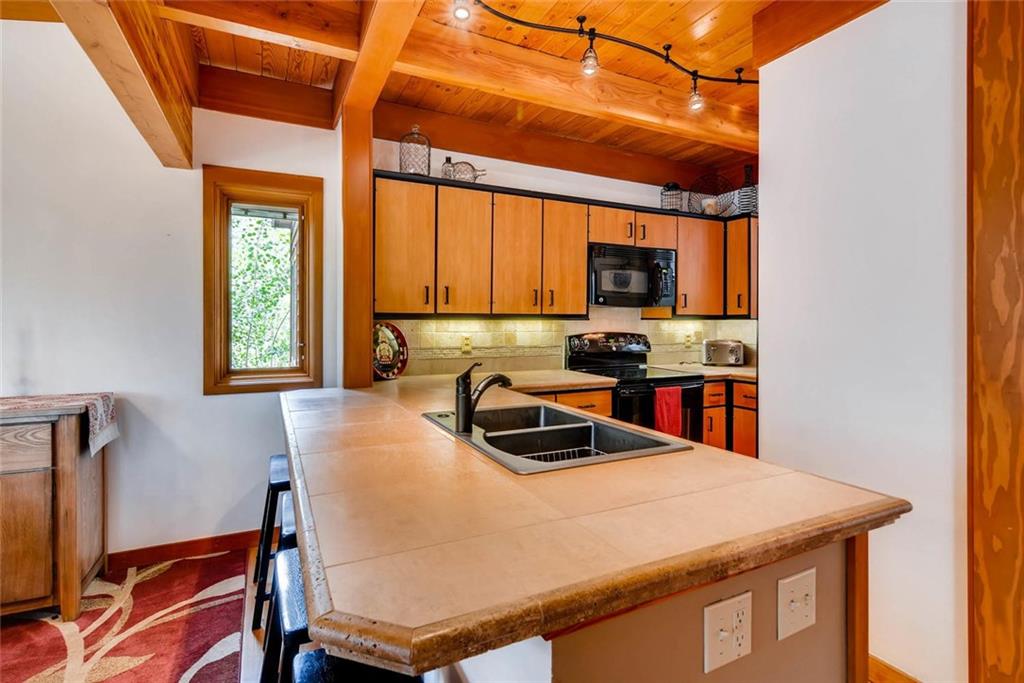 650 Tennis Club Road, Unit 1340 Keystone, CO 80435 - Photo 9 of 25 a kitchen with a stove a sink and a microwave