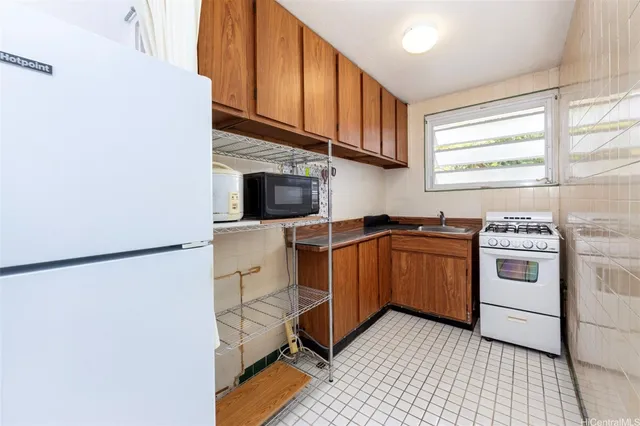 a kitchen with stainless steel appliances a stove a microwave and a refrigerator