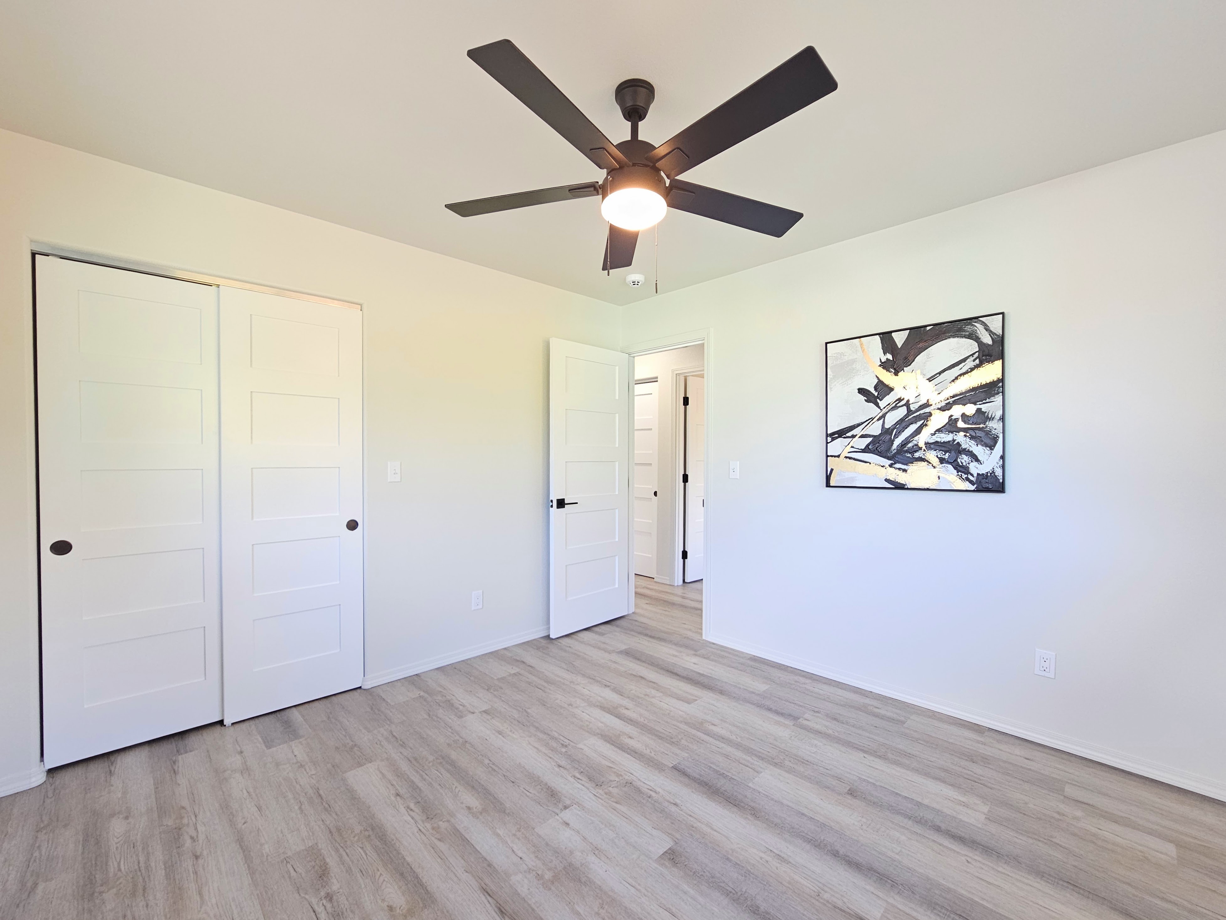 11-3385 Old Volcano Road Volcano, HI 96785 - Photo 15 of 30 an empty room with wooden floor and ceiling fan