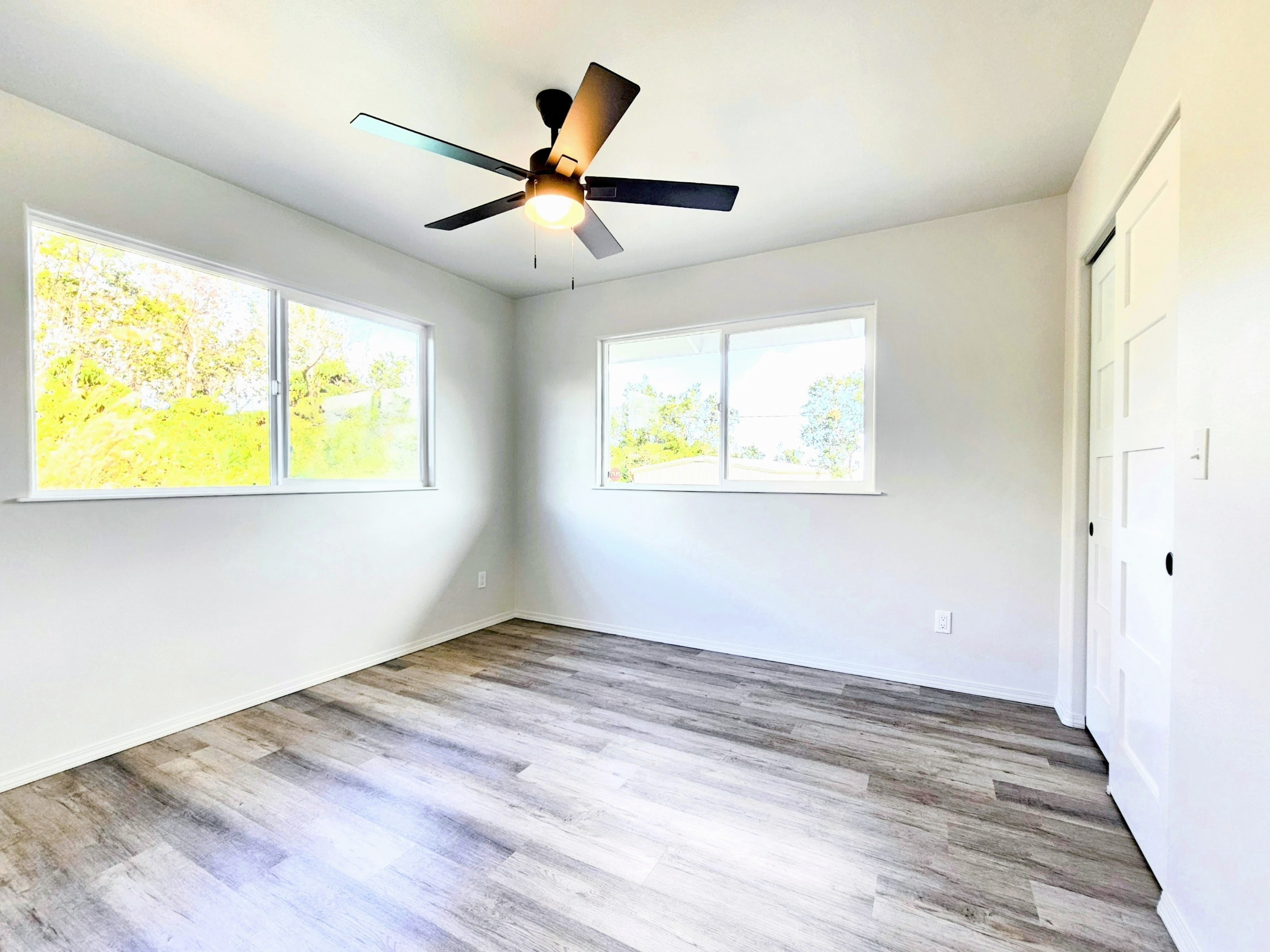 11-3385 Old Volcano Road Volcano, HI 96785 - Photo 16 of 30 a view of an empty room with wooden floor and a window