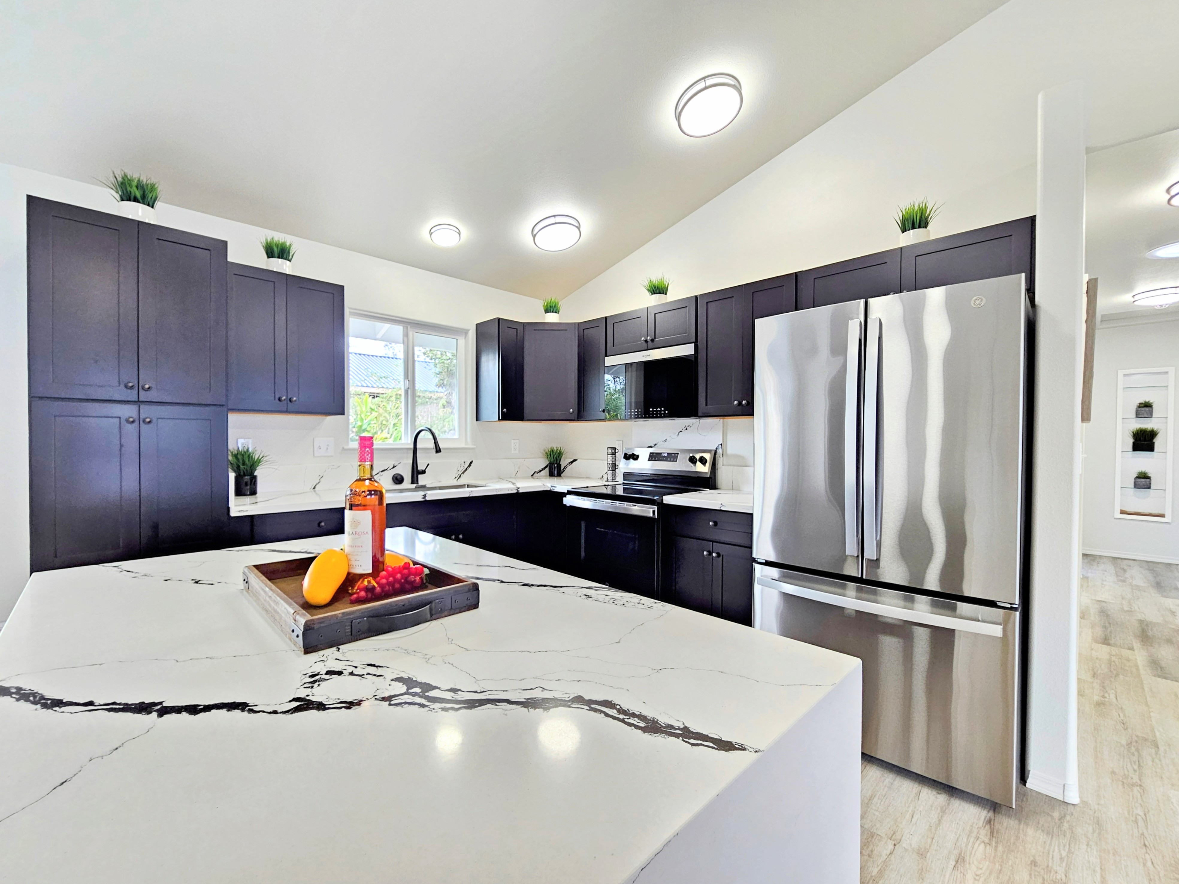 11-3385 Old Volcano Road Volcano, HI 96785 - Photo 4 of 30 a kitchen with a refrigerator a stove and a wooden cabinets