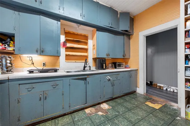 a kitchen with sink and cabinets