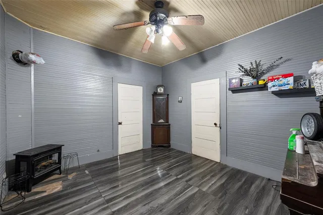 a view of a livingroom with wooden floor and a ceiling fan