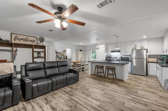 a living room with furniture and kitchen view