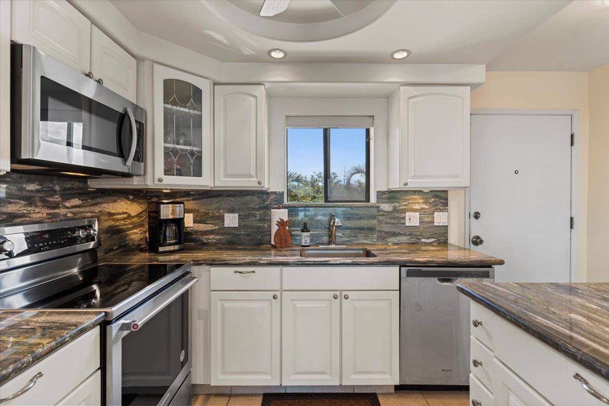 36 South Kihei Road, Unit 301 Kihei, HI 96753 - Photo 12 of 30 a kitchen with stainless steel appliances granite countertop a sink stove and microwave