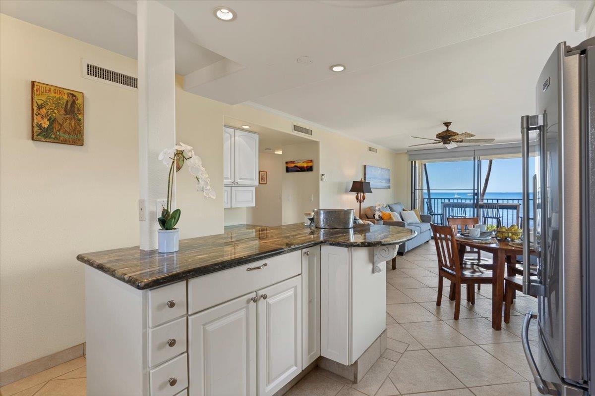 36 South Kihei Road, Unit 301 Kihei, HI 96753 - Photo 16 of 30 a kitchen with stainless steel appliances granite countertop a sink and a refrigerator
