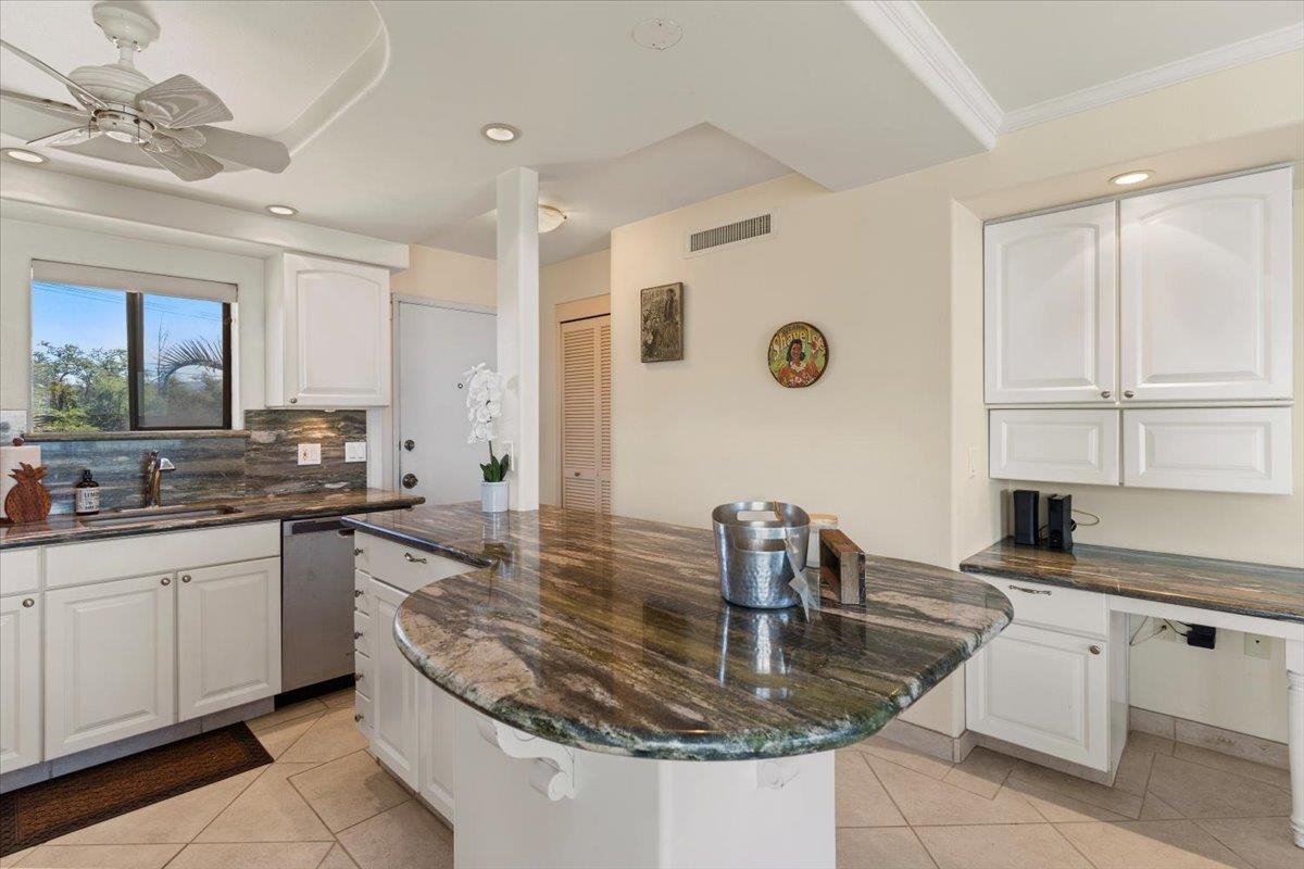 36 South Kihei Road, Unit 301 Kihei, HI 96753 - Photo 17 of 30 a kitchen with stainless steel appliances granite countertop a sink a stove and cabinets