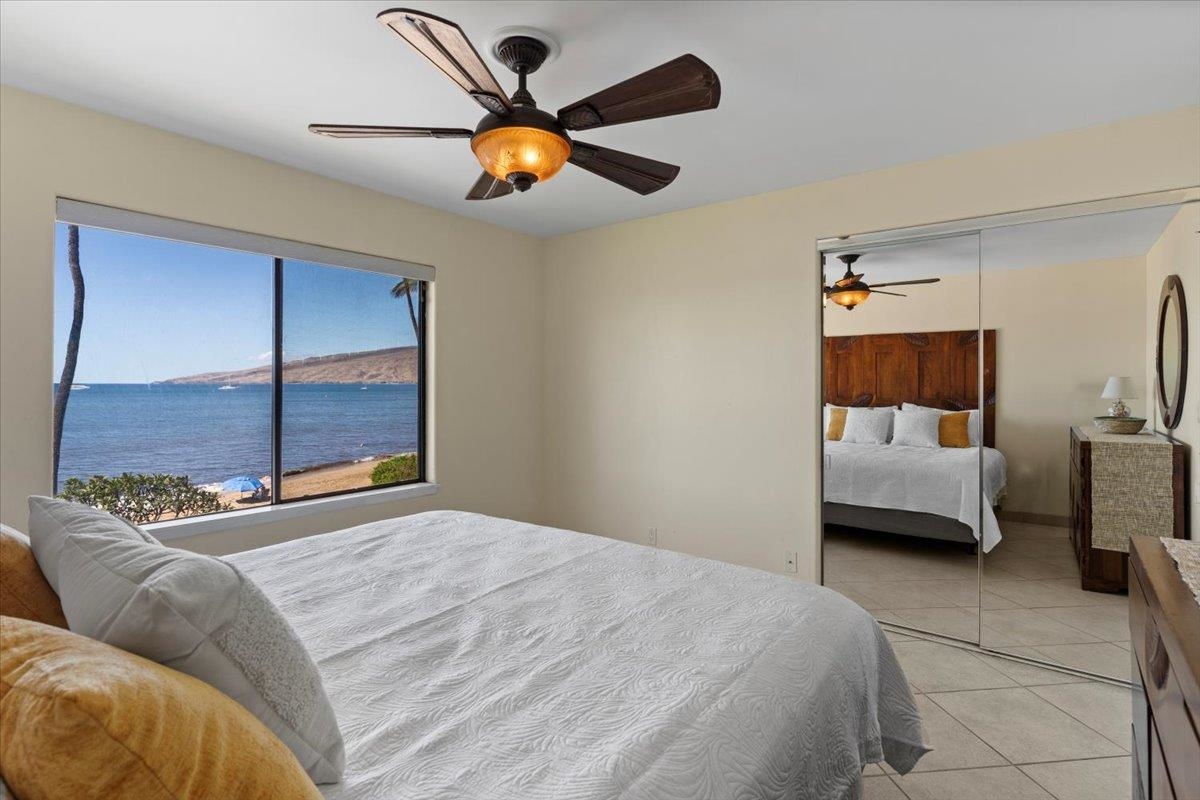 36 South Kihei Road, Unit 301 Kihei, HI 96753 - Photo 20 of 30 a bedroom with a bed and a chandelier