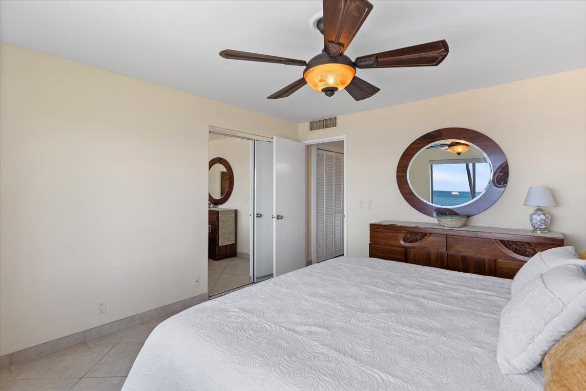 36 South Kihei Road, Unit 301 Kihei, HI 96753 - Photo 22 of 30 a bedroom with a bed and a chandelier