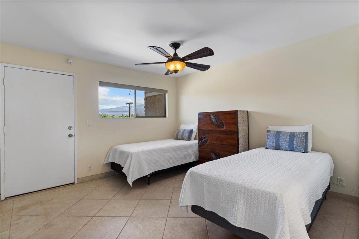36 South Kihei Road, Unit 301 Kihei, HI 96753 - Photo 26 of 30 a bedroom with two beds and a chandelier