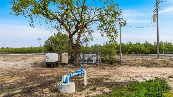 a backyard of a house with fountain table and chairs