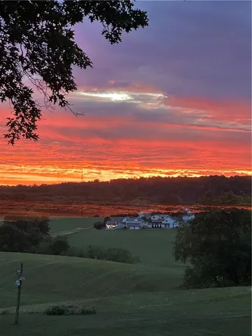 a view of a small house with yard