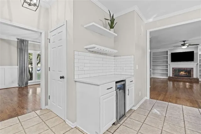 a hallway view with fireplace and flat screen tv