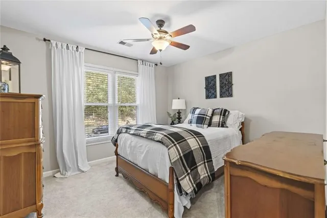 a bedroom with bed and a large window