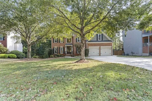 a house that has a tree in front of it