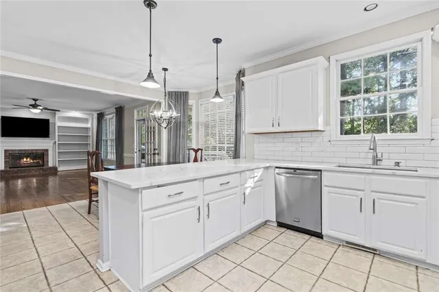 a kitchen with white cabinets appliances and a sink