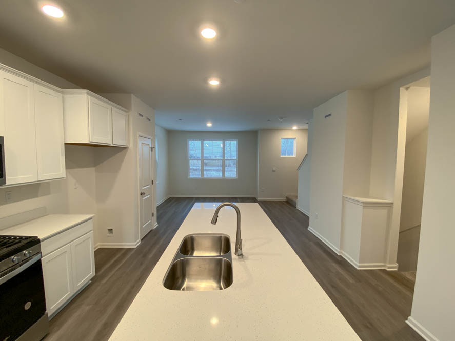 577 Yosemite Way Mundelein, IL 60060 - Photo 9 of 42 a kitchen with a refrigerator and white cabinets