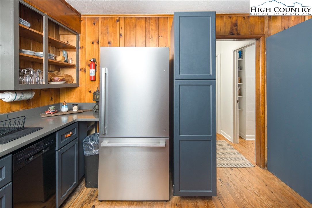 190 Bradley Court Boone, NC 28607 - Photo 5 of 28 a kitchen with stainless steel appliances granite countertop a refrigerator and a wooden floor