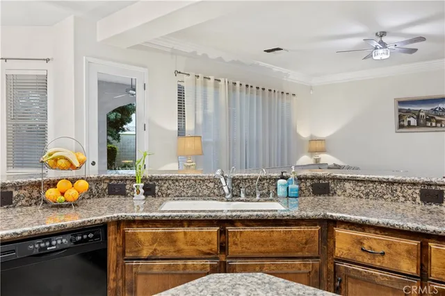 a kitchen with stainless steel appliances granite countertop a sink stove and cabinets