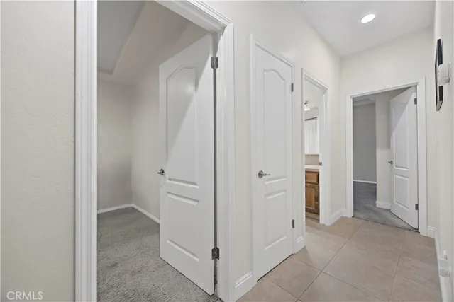 a view of a bathroom with closet and mirror